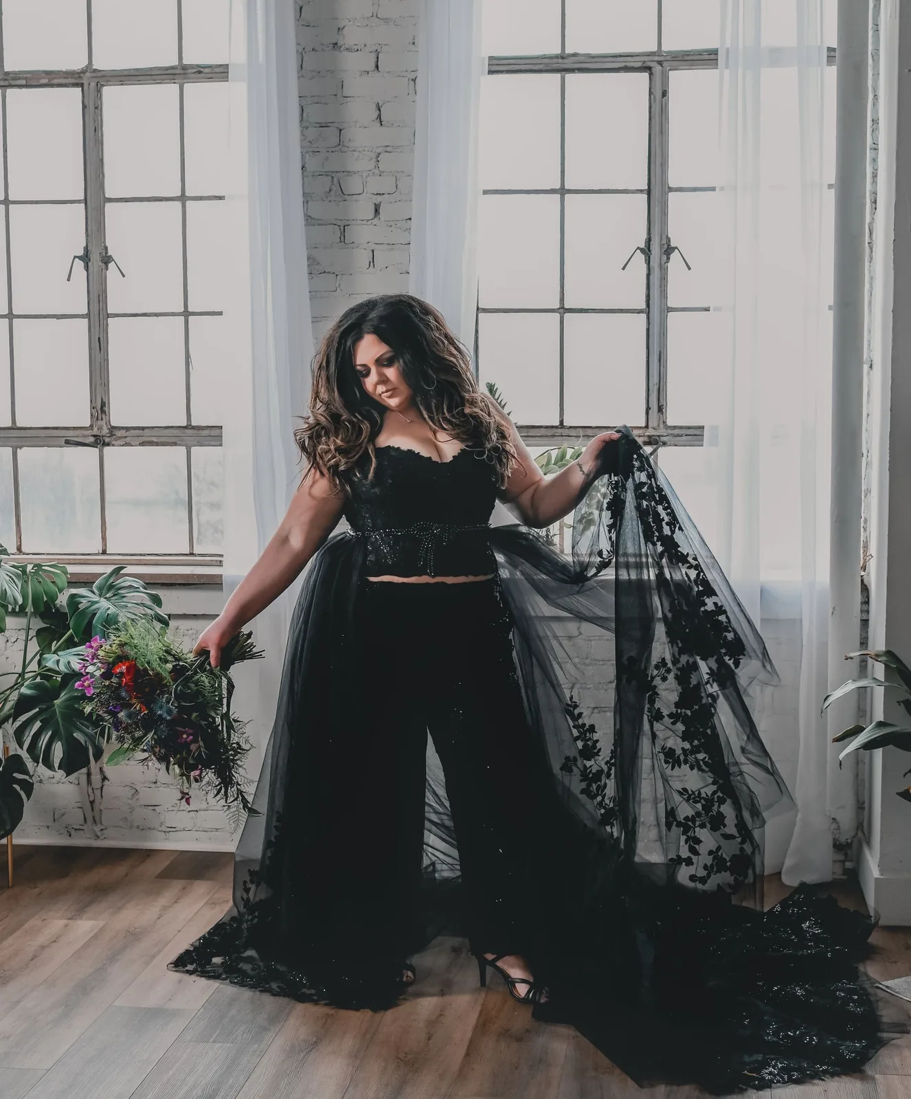 Bride in a black gown in an emerald room