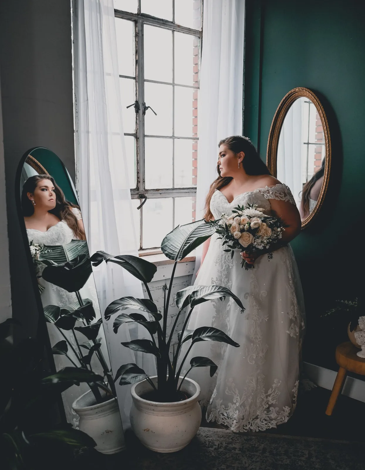 Bride by a window in an emerald room